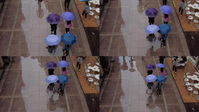 雨天街道行人打伞逛街