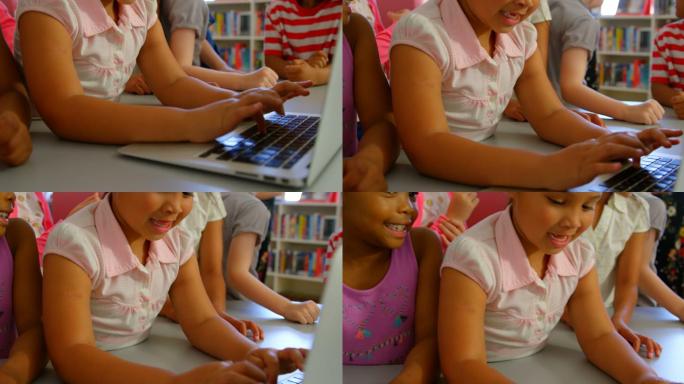 女学生在学校图书馆一起学习笔记本电脑
