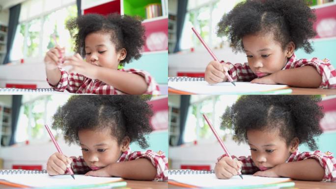 儿童用彩色铅笔在纸上画画。