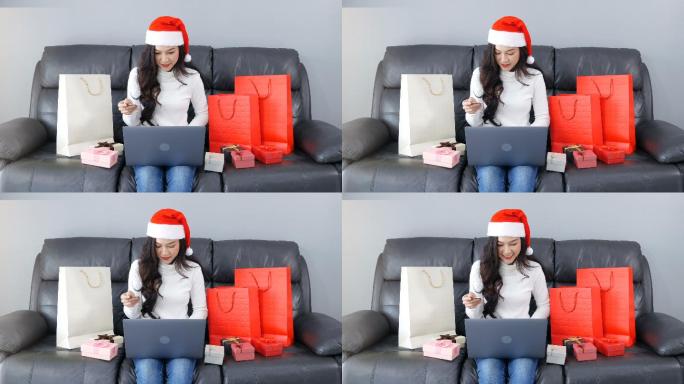 戴着圣诞帽在网上购物的女人