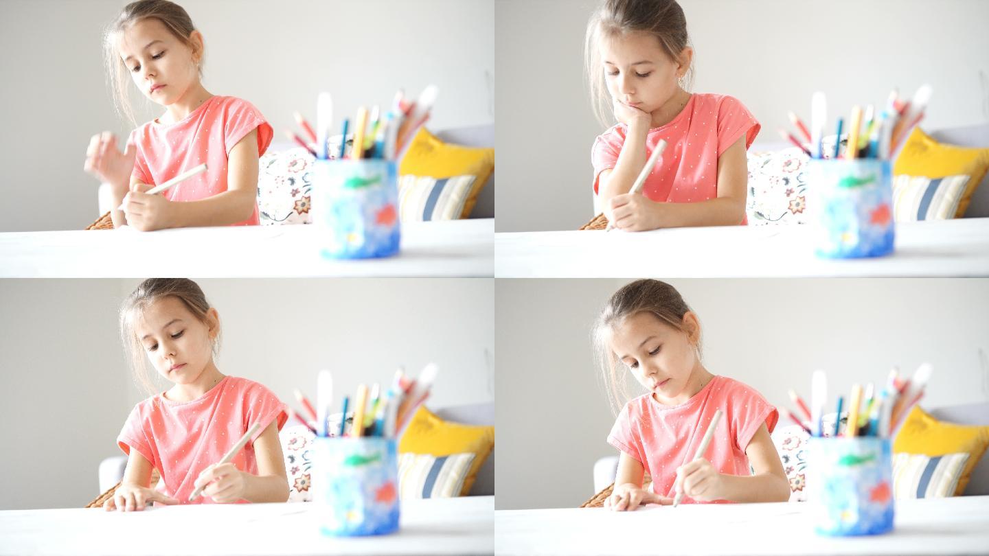 小女孩在书桌上用彩色笔画画