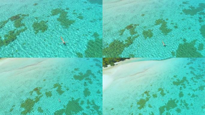 女游客仰面漂浮在清澈的海水上