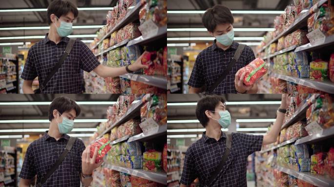 年轻的男子在超市购物，戴上口罩