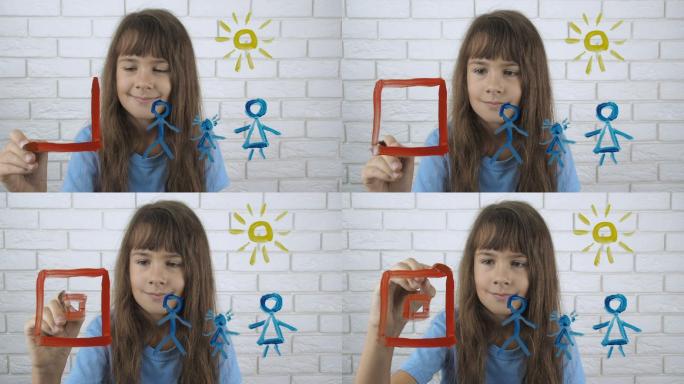 快乐的孩子画房子。小女孩画颜料。