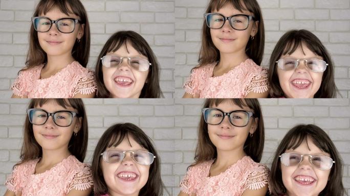 快乐的姐妹戴着眼镜看镜头。