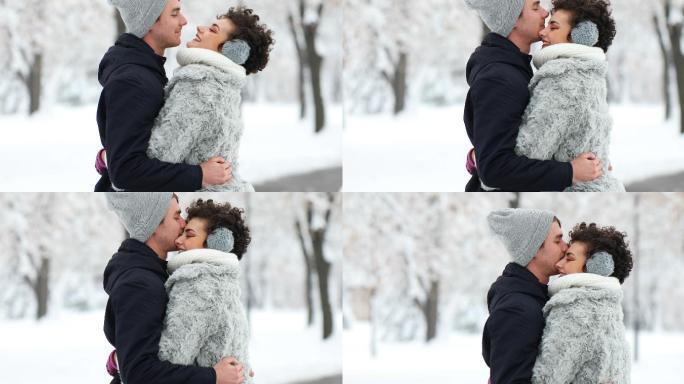 年轻夫妇在雪中拥抱