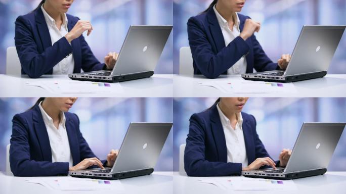 女性经理通过笔记本电脑发送电子邮件