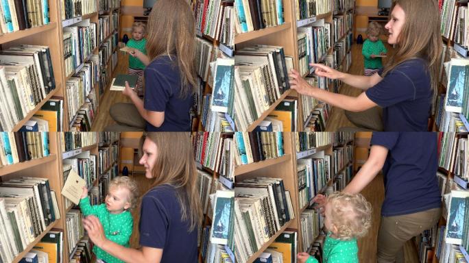 在图书馆为她的女儿挑选书籍