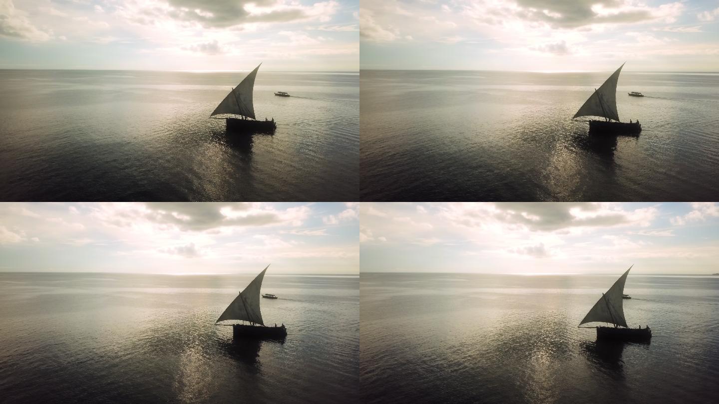 无人机拍摄的日落时分海上帆船的画面