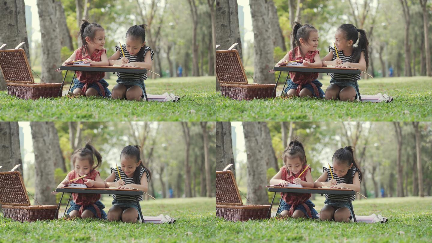 亚洲可爱的小女孩在公园画画。