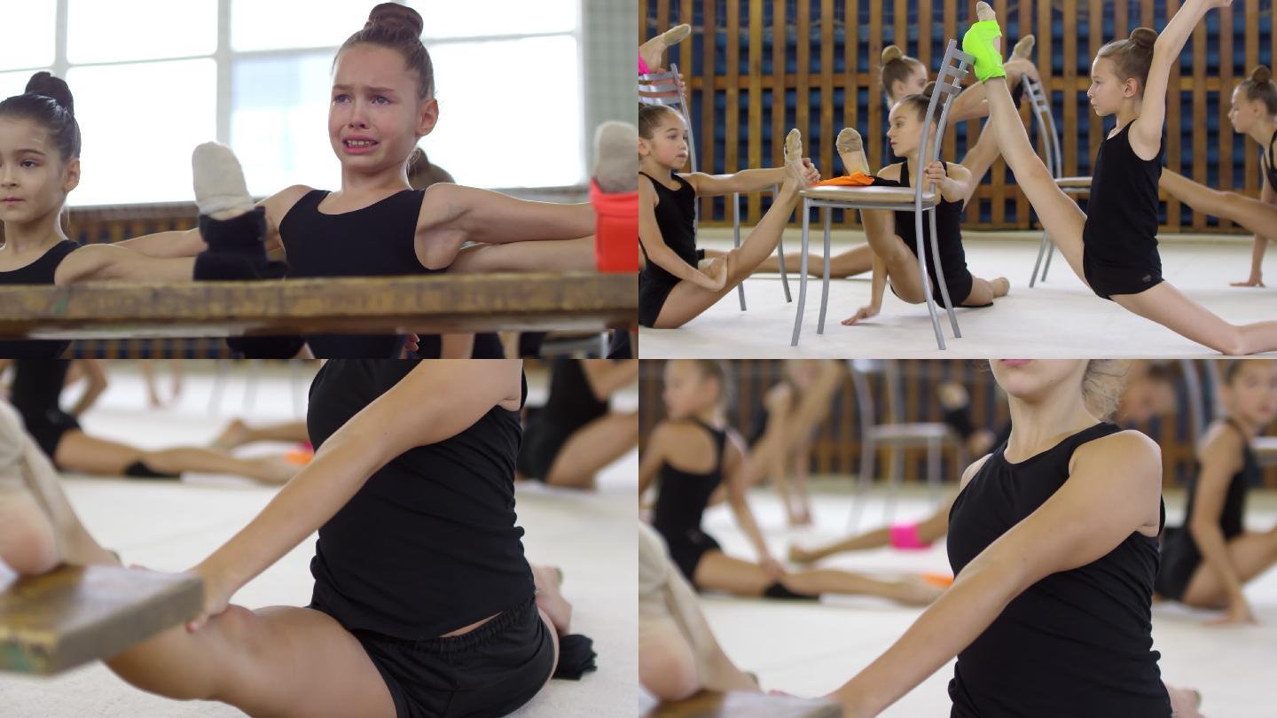 女孩穿着紧身衣在舞蹈课上用椅子做伸展运动