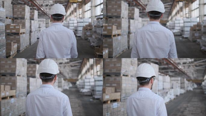 工程师男戴着安全帽在仓库施工现场工作