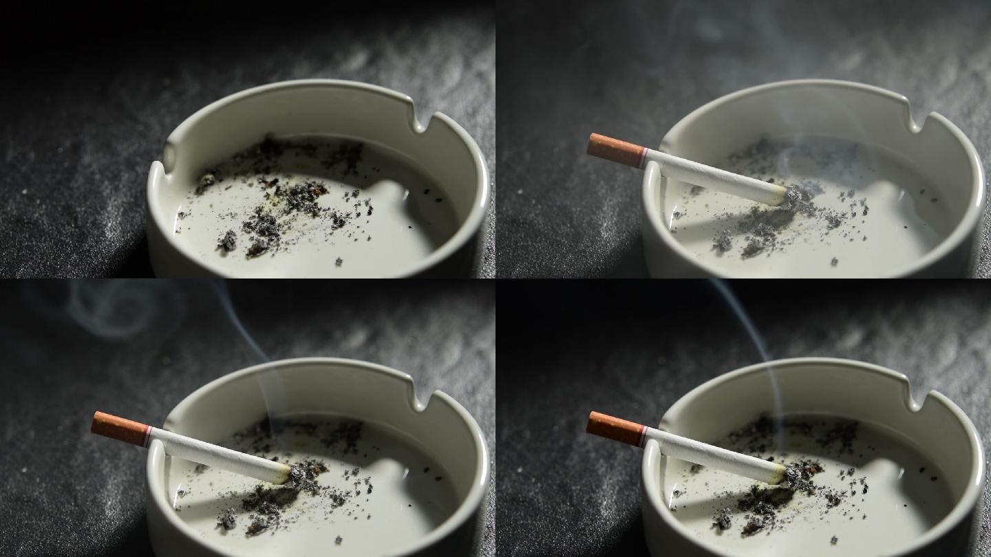 手把点燃的香烟放在烟灰缸上的画面