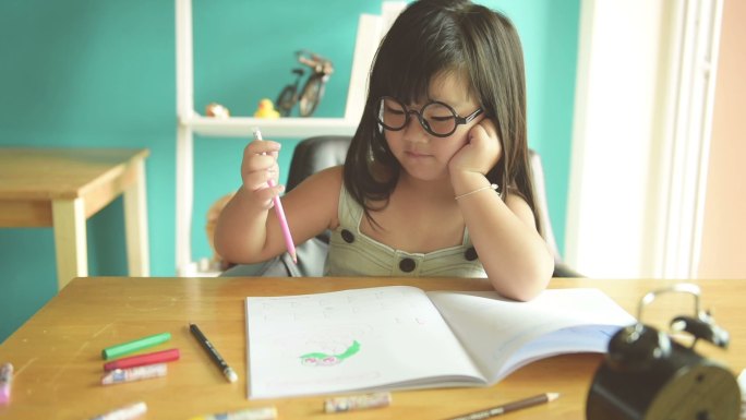 快乐的小女孩在桌子上画画