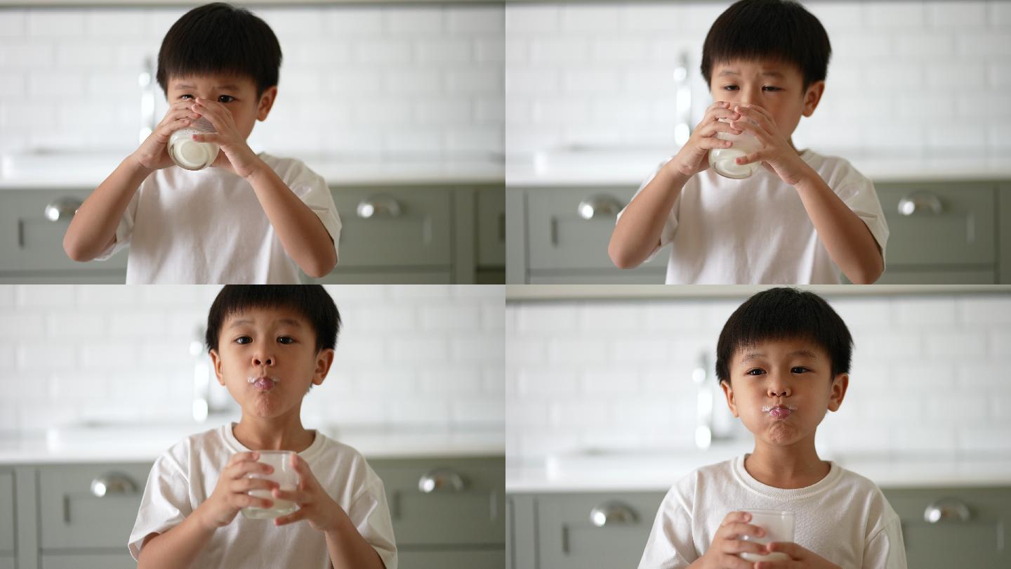 小男孩喝牛奶小孩开心的喝牛奶吃营养早餐奶