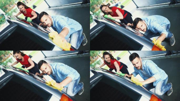 夫妇洗他们的车的特写前视图