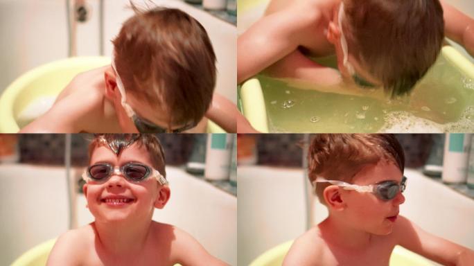 戴着护目镜在浴缸里的小男孩