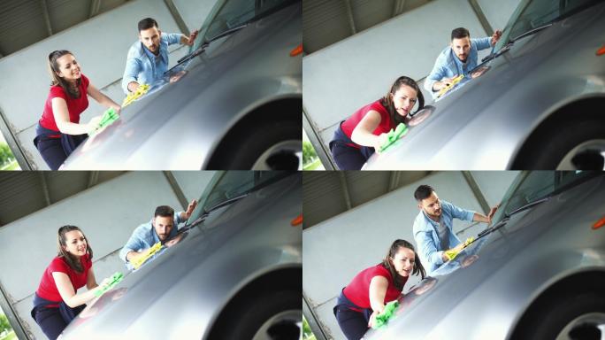 夫妇洗他们的车的特写前视图。