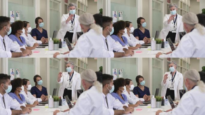 医学学生戴着防护口罩倾听医学教授。