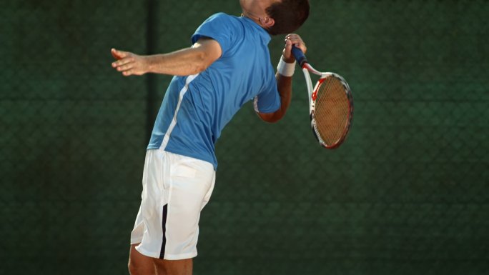 一名职业网球运动员在球场上发球