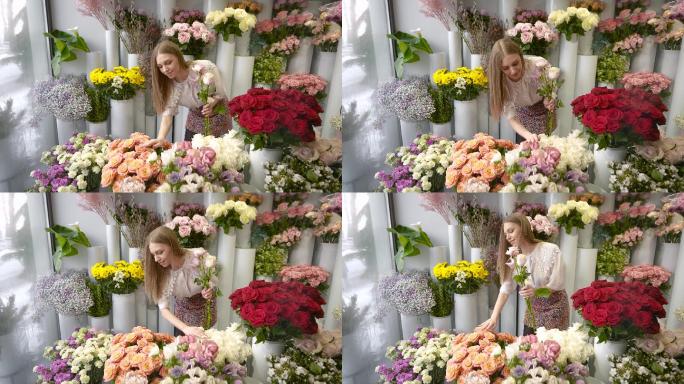 一个女人在花店里收集一束花。