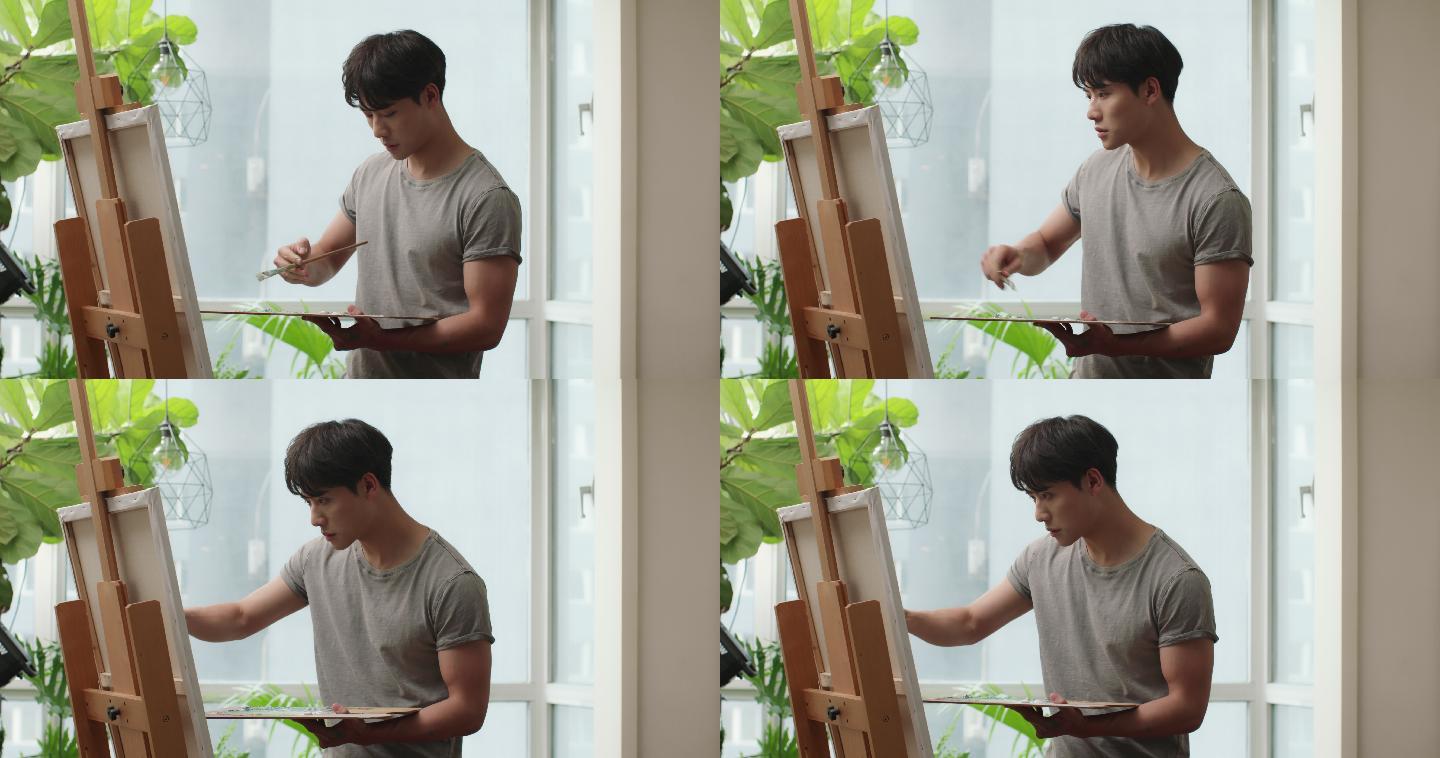 年轻男子在家画画青年人作画木镶板