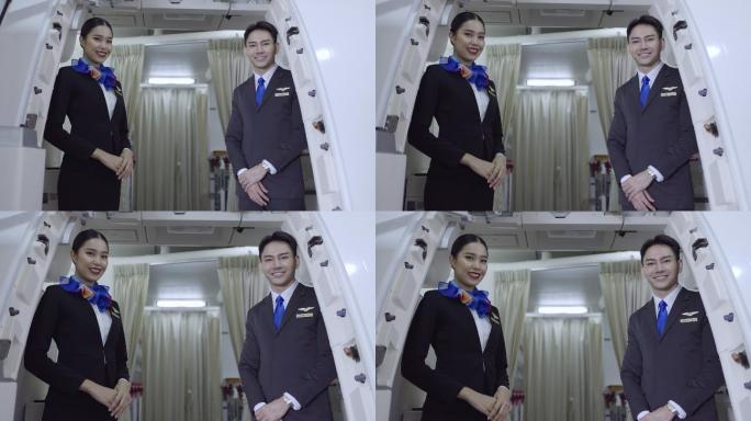 微笑的年轻乘务员站在飞机入口处