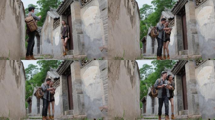 年轻情侣在村落里拍照