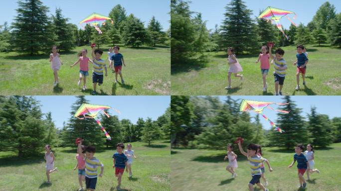 快乐儿童在草地玩风筝