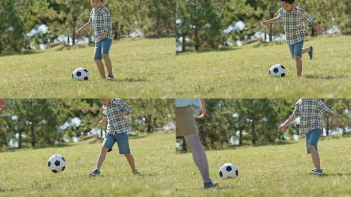 快乐的父子俩在草地上踢足球