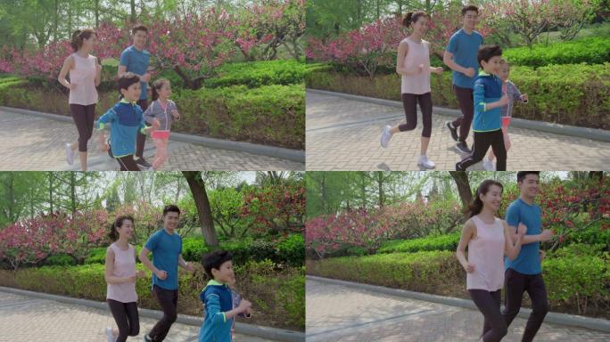 快乐的年轻家庭在公园跑步