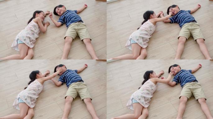 快乐的姐弟俩躺在地板上
