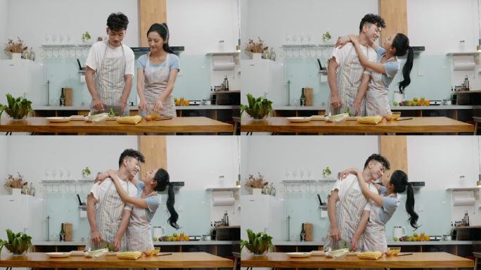 甜蜜的年轻夫妇在厨房做饭