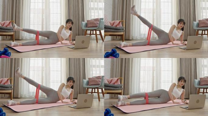 年轻女子在家健身做瑜伽锻炼身体居家休闲
