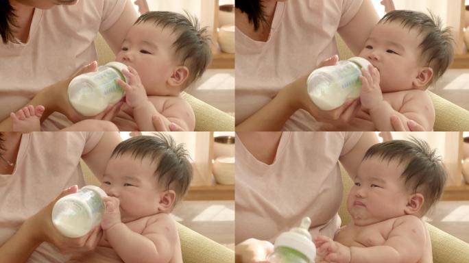 母亲抱着婴儿喂奶婴儿奶瓶抱