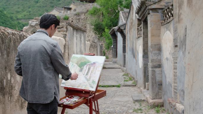 年轻男士在户外绘画