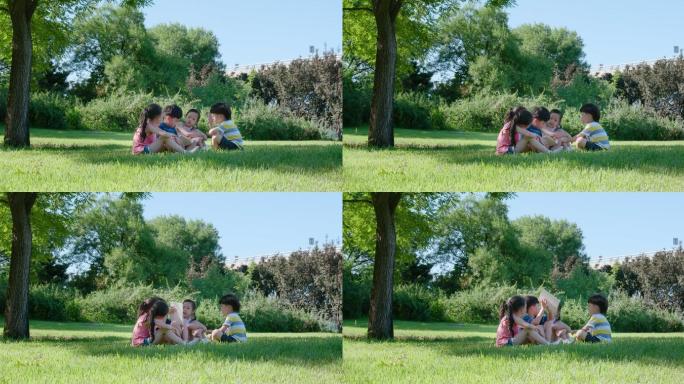 快乐的儿童在草地上读书