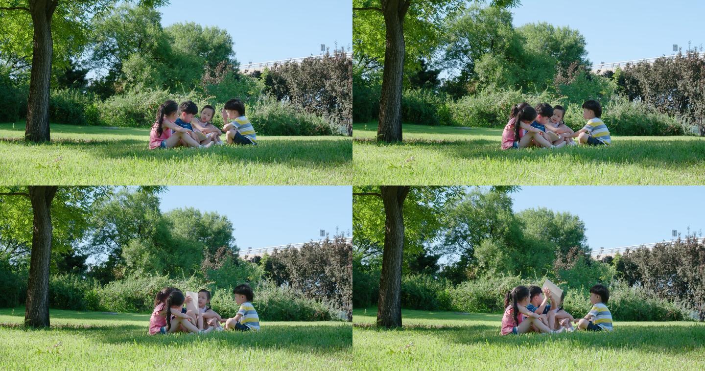 快乐的儿童在草地上读书