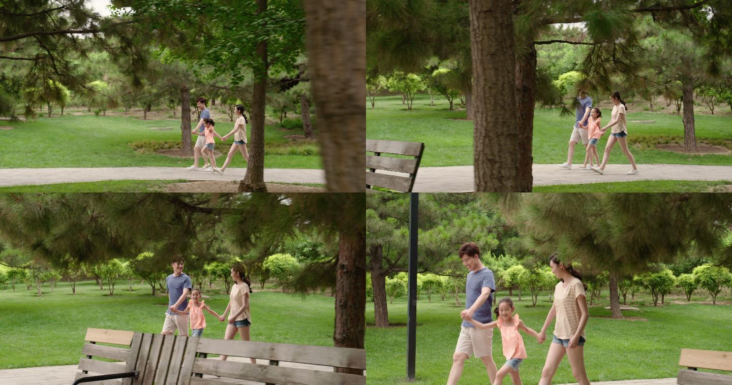 快乐的年轻家庭在公园散步