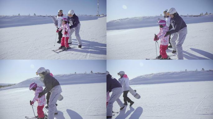 年轻父母教女儿滑雪