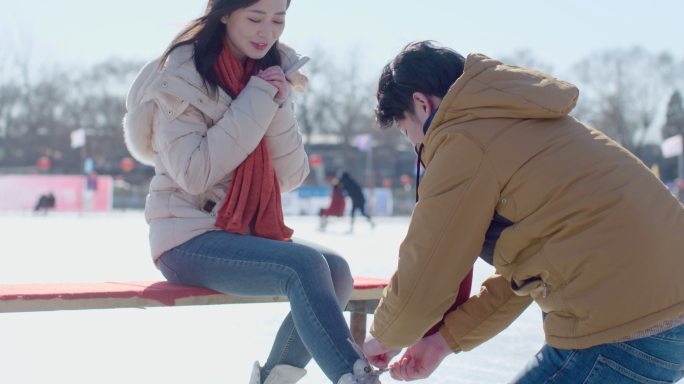 年轻情侣户外滑冰溜冰鞋