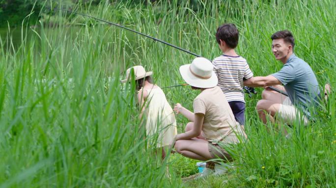 快乐的年轻家庭在河边钓鱼