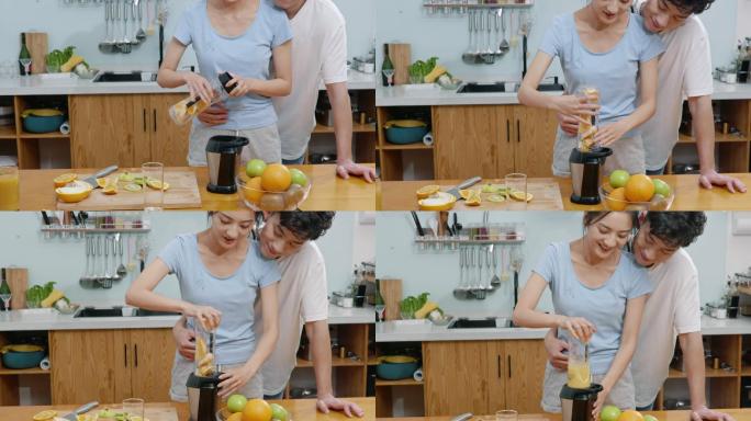 快乐的年轻夫妇在厨房榨果汁