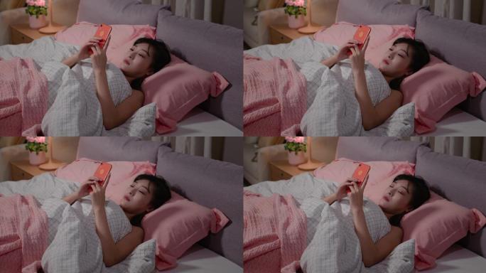 年轻女士睡前玩手机