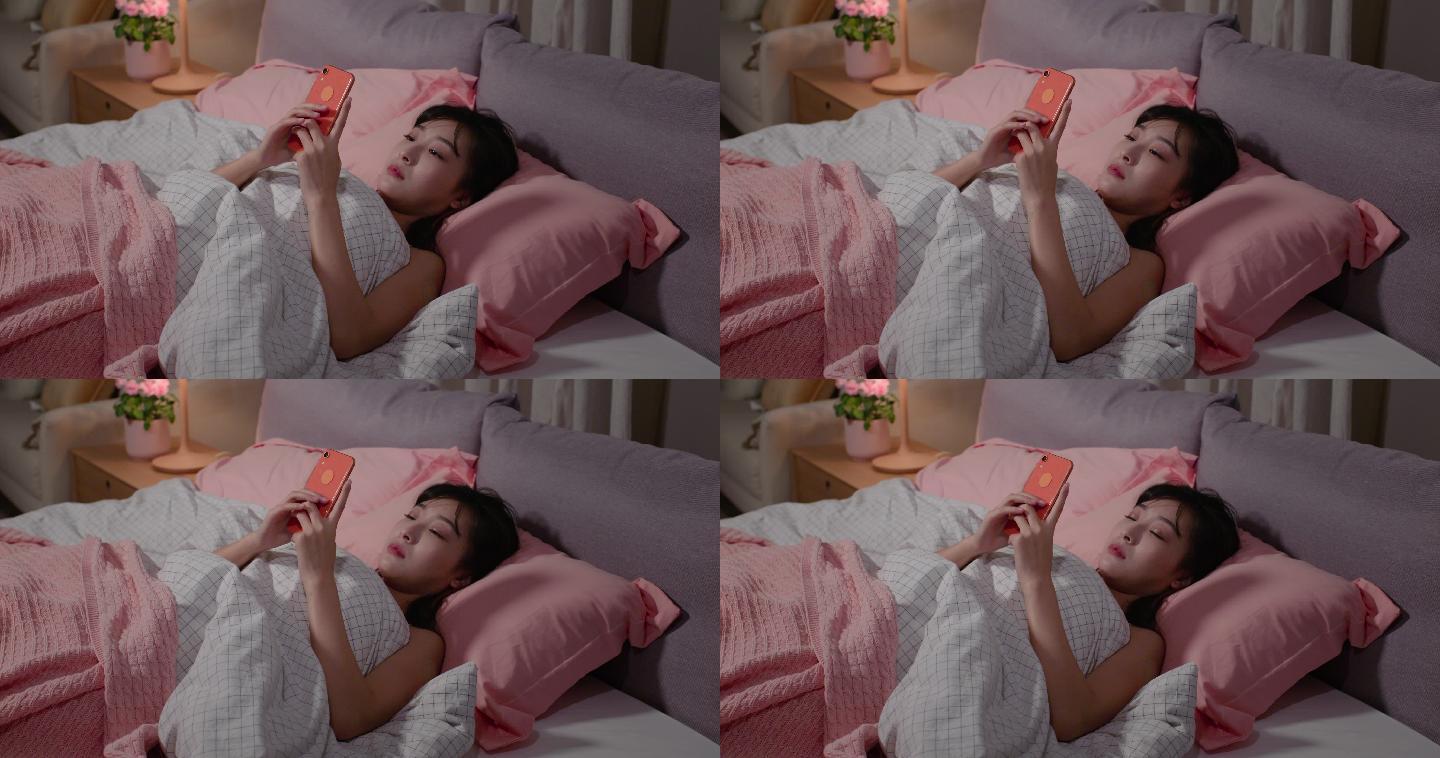 年轻女士睡前玩手机