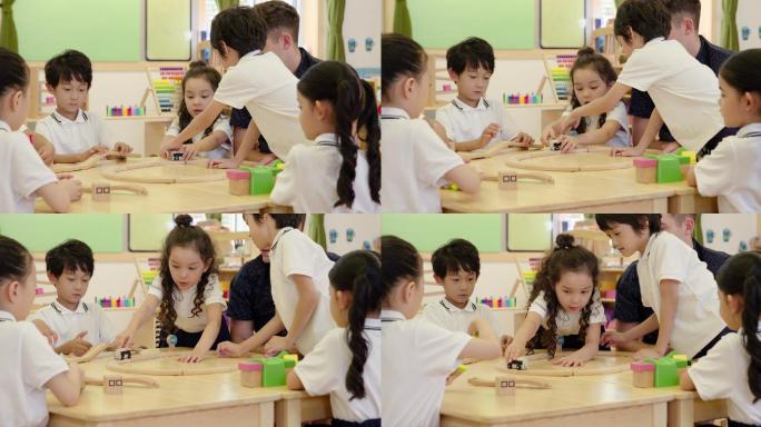 幼儿园外教和孩子们在教室玩火车模型