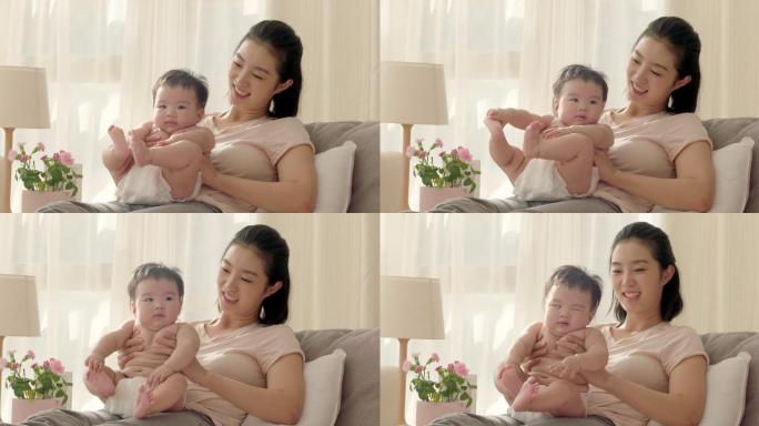 母亲抱着婴儿哺乳期母子哺育养育母爱