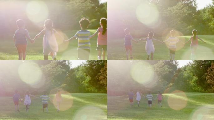 儿童在草坪上玩耍后背树手牵手