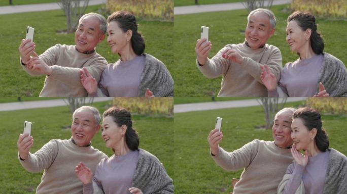 老年夫妇在公园使用手机