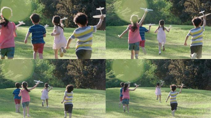 儿童在草坪上玩耍小孩子奔跑纸飞机